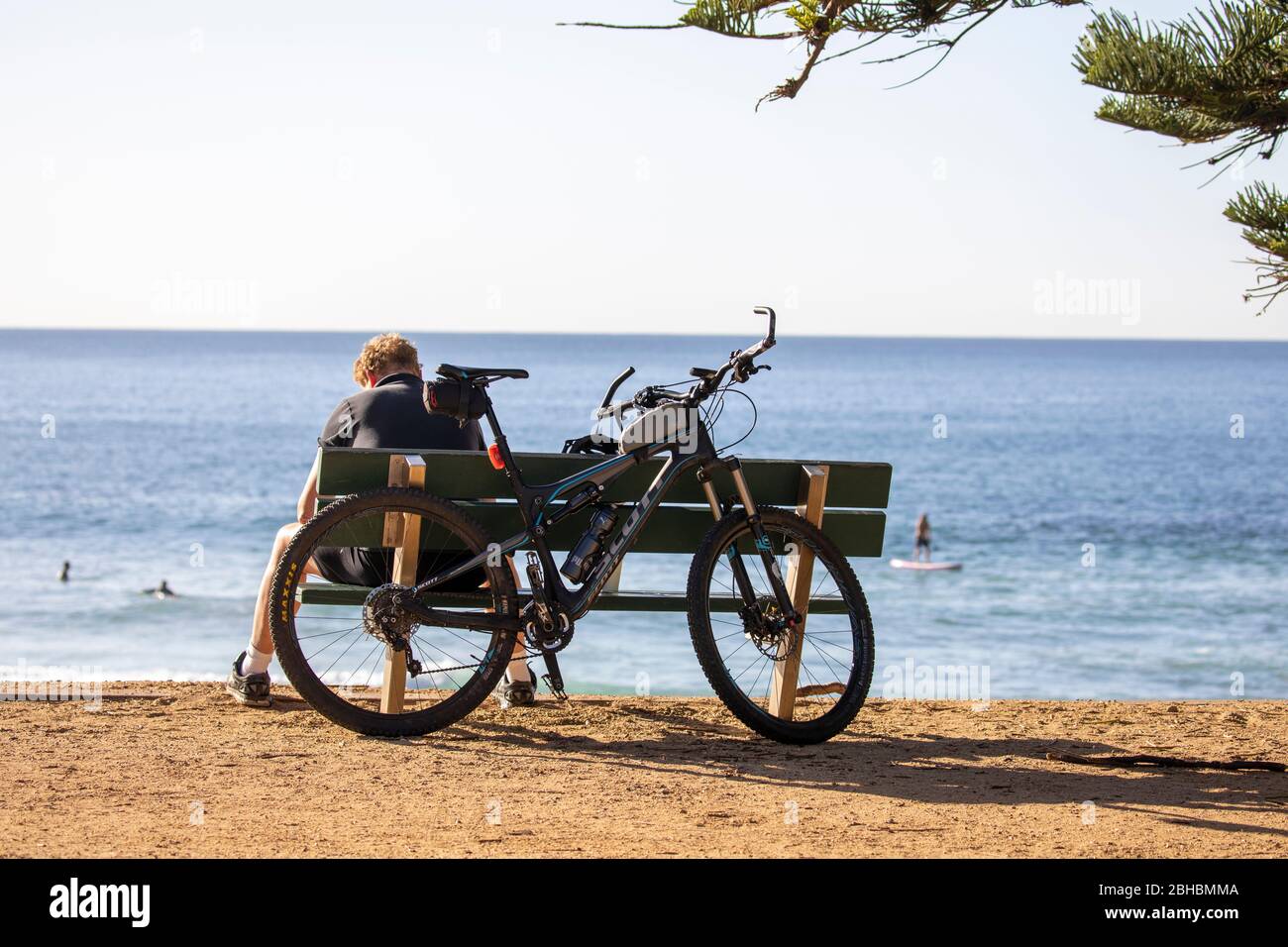 Australian man takes a rest from riding his scott mountain bike by a Sydney beach,NSW,Australia Stock Photo