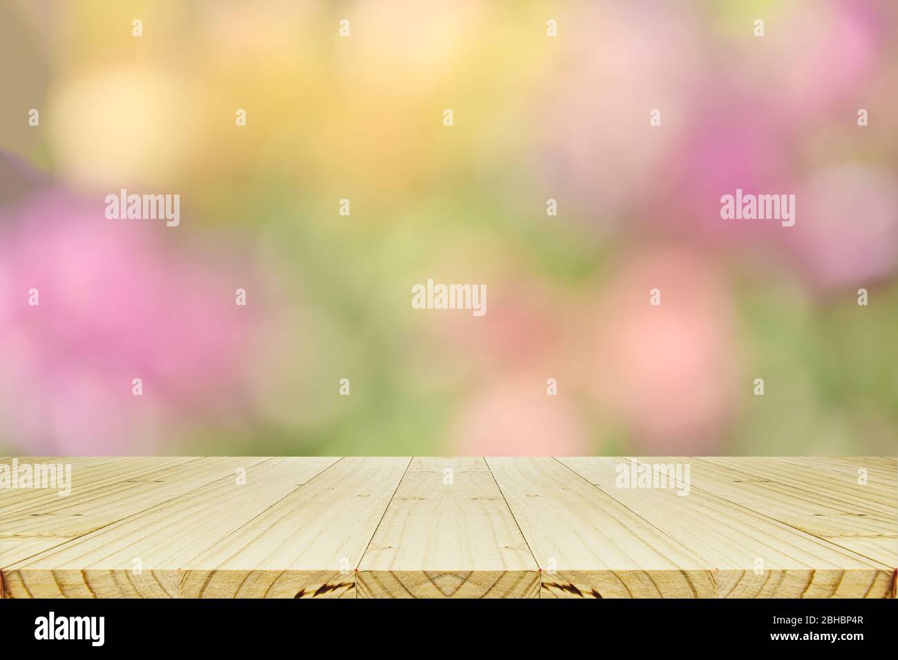 Perspective wood counter and abstract background with bokeh in pastel tone for spring, summer and blooming seasons. Stock Photo