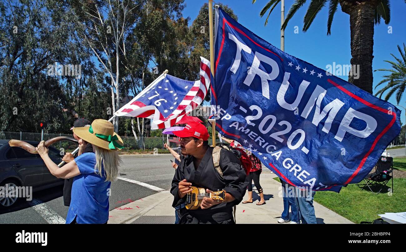 OpenUpCA,  Newport Beach,California, 24th of April, 2020, protesters rallying around the outskirts of  Newport beach , waving american flags demanding reopen California. Stock Photo