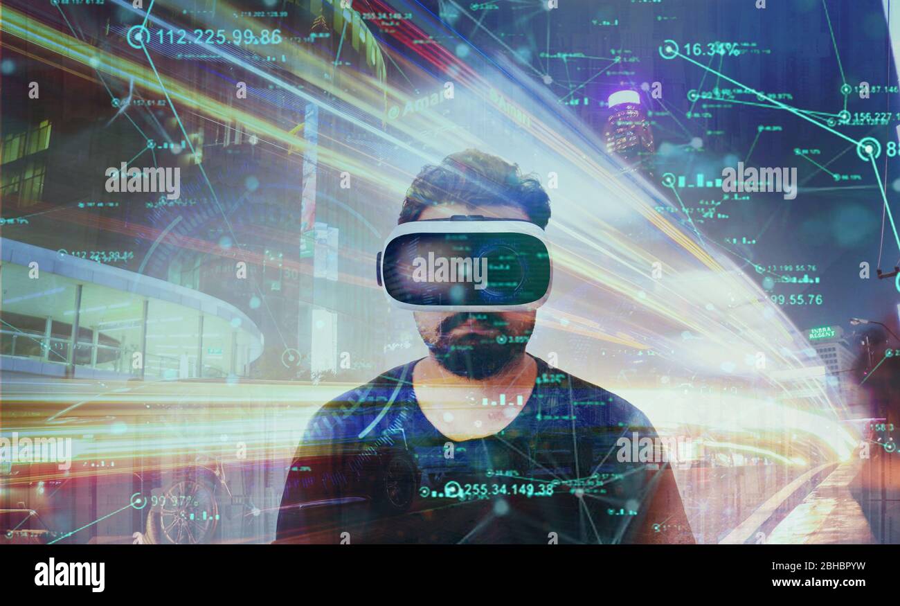 Young Guy in black t shirt looking through VR (Virtual Reality) glasses - Virtual World Stock Photo