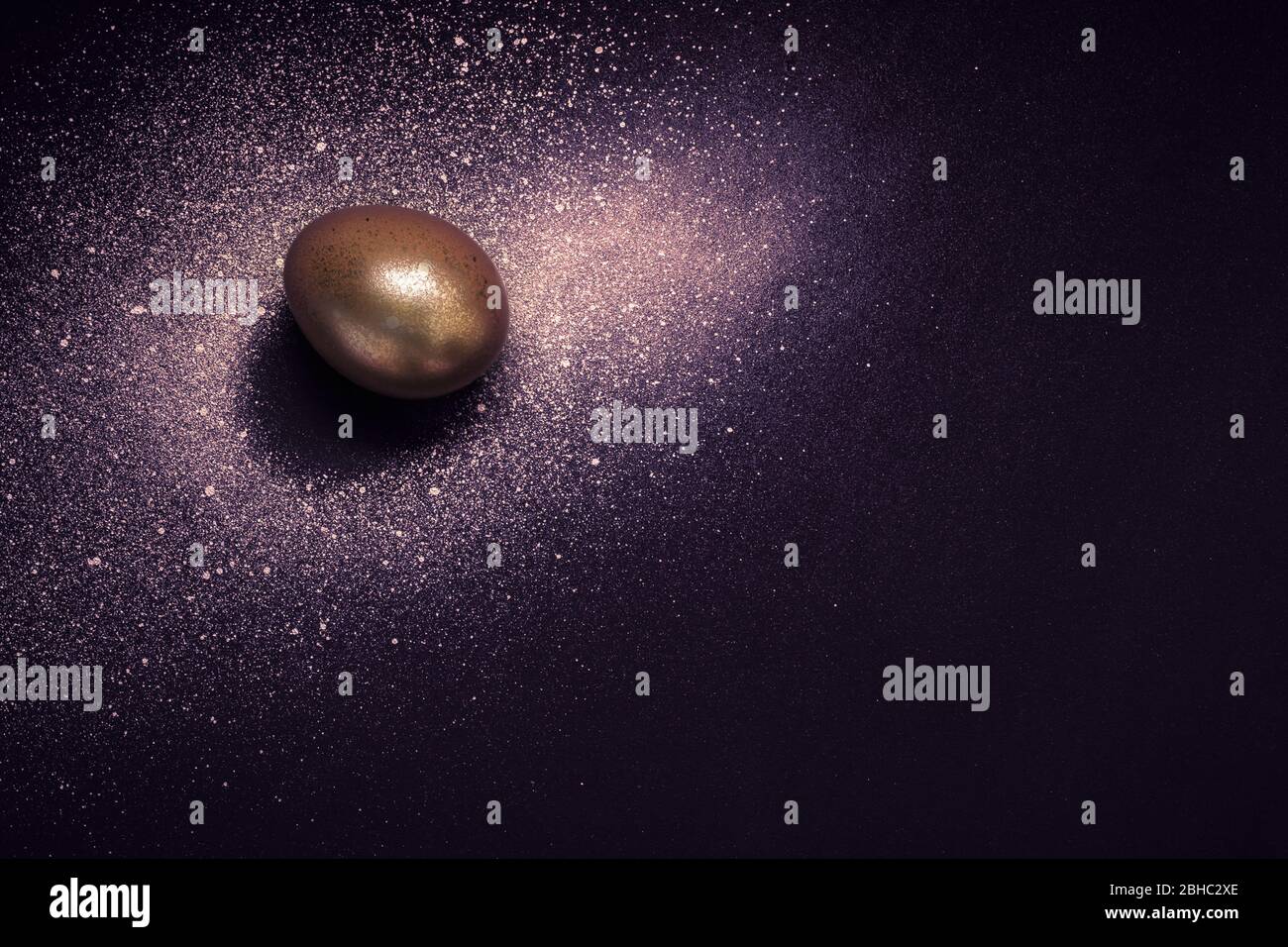 Golden Egg And Paint Spray Galaxy On Purple Background Abstract