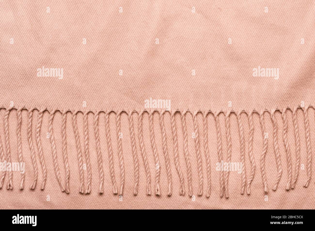 Pink plaid with tassels. Cozy soft fabric background with copy space. Stock Photo