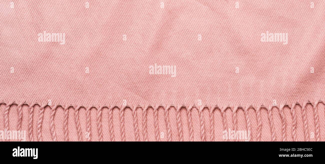 Pink plaid with tassels. Cozy soft fabric banner with copy space. Stock Photo