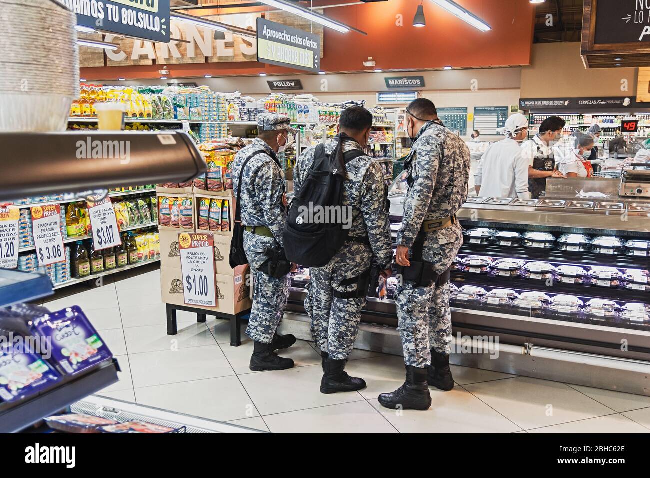 Apr. 1, 2020 - Police officers making purchases in a supermarket in the capital of El Salvador during the quarantine. Stock Photo