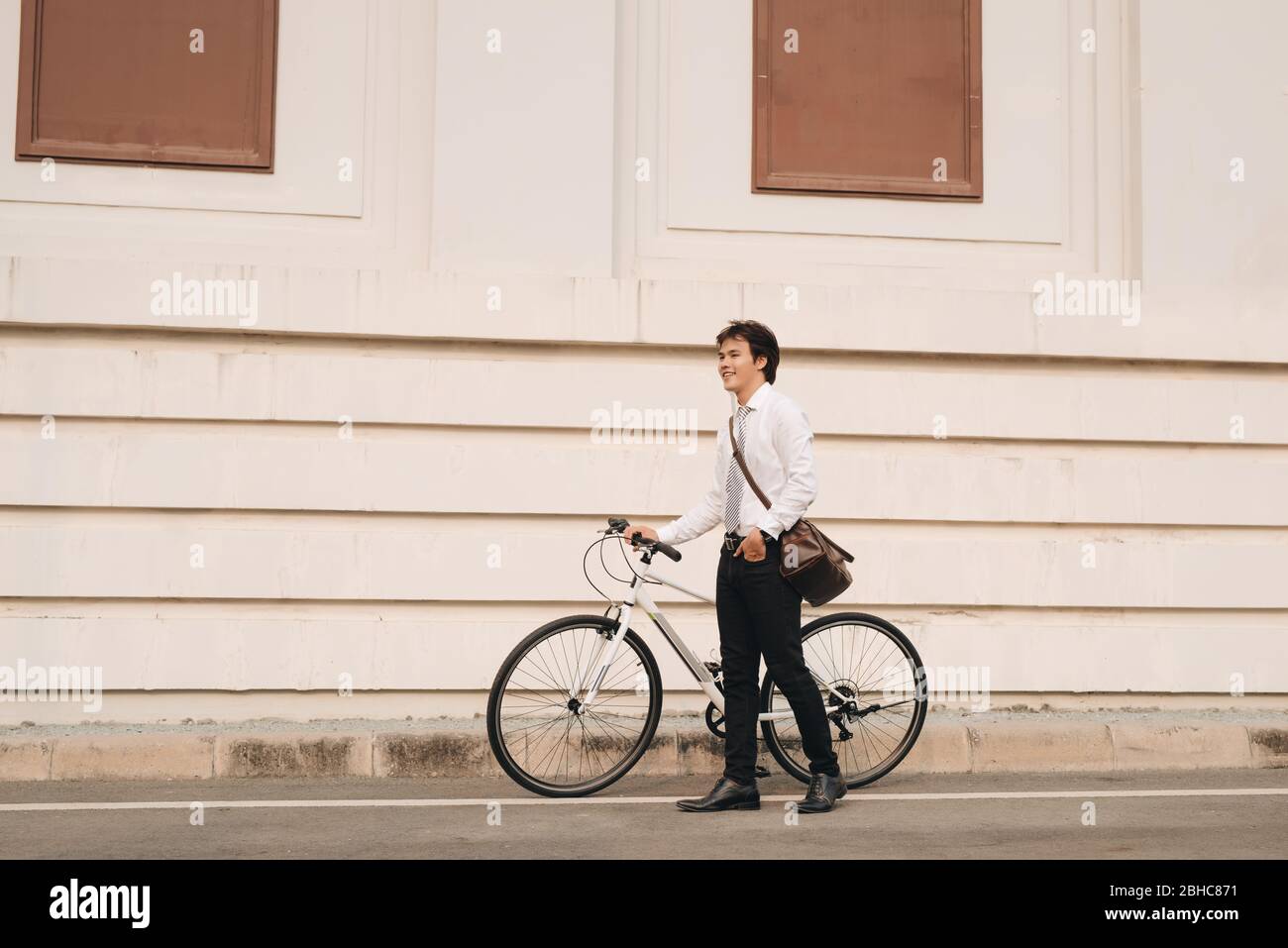 Outdoor portrait of handsome young man with fixed gear bicycle in the street. Stock Photo