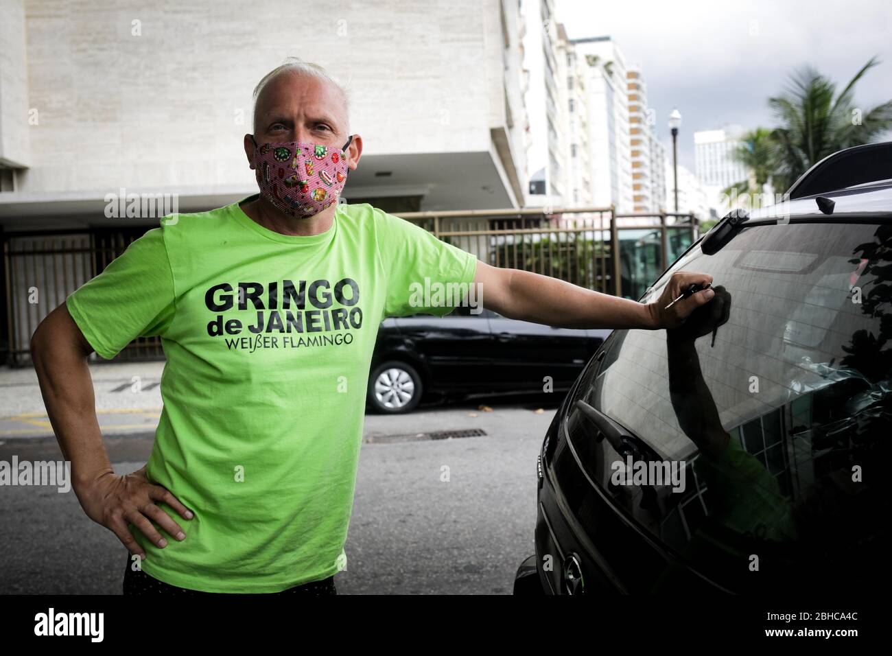 Rio De Janeiro, Brazil. 17th Apr, 2020. The tourist guide Bernhard Weber stands next to his car wearing a face mask before he sets off for the Rocinha favela to distribute food and hygiene products. Together with Kuranyi, Weber has been looking for a direct way to help the favelas, which are particularly affected by the Covid 19 pandemic. (to dpa 'Kuranyi's favela aid in Rio' from 25.04.2020) Credit: Ian Cheibub/dpa/Alamy Live News Stock Photo