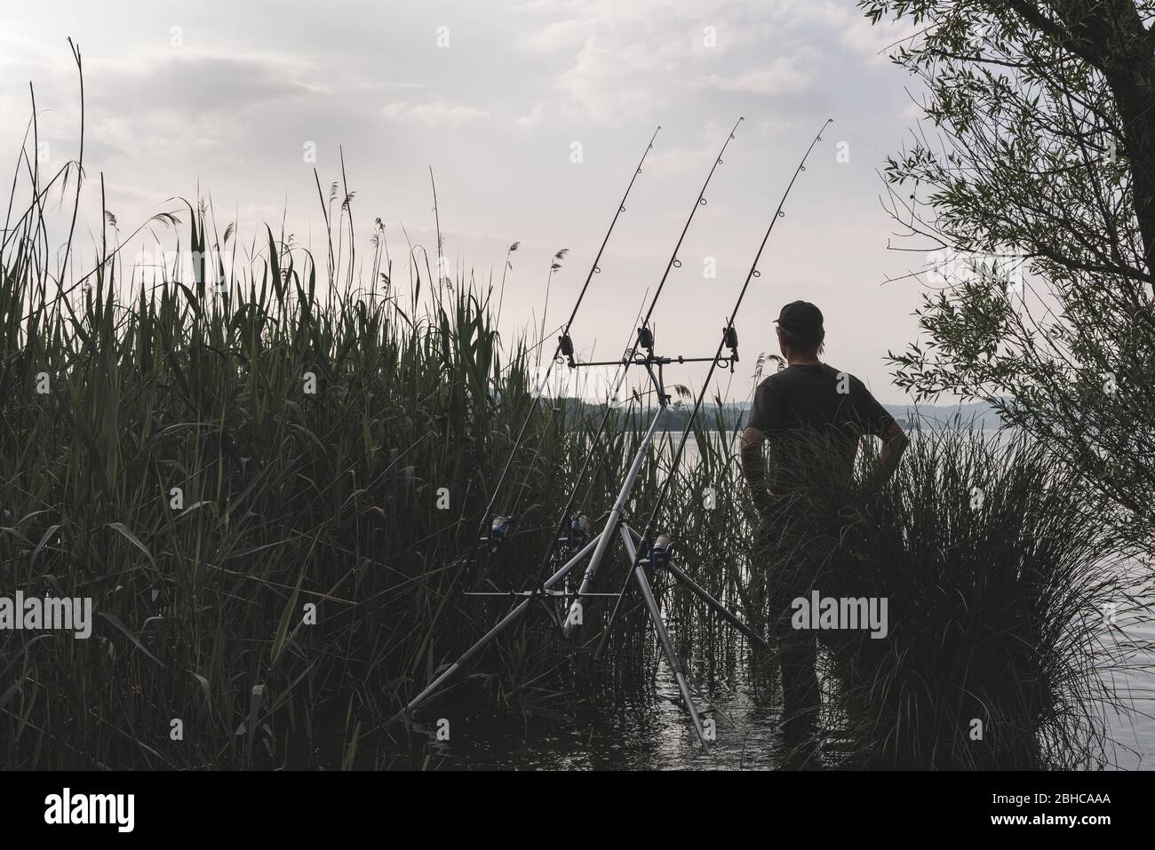 Fishing adventures, carp fishing. Man fishing on lake Stock Photo