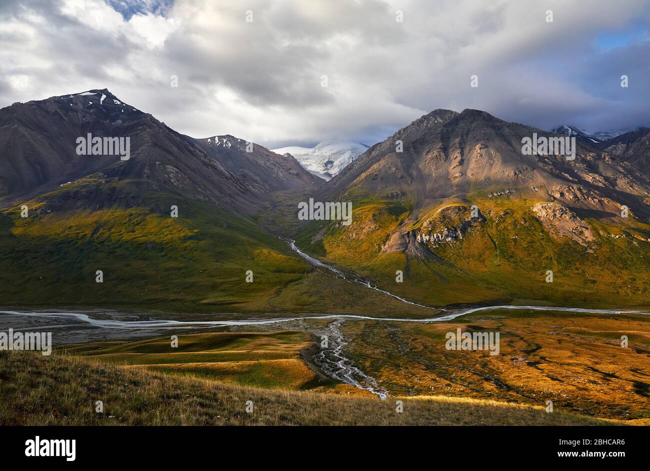 Beautiful landscape of mountain valley at sunrise cloudy sky of Terskey Alatau in Kyrgyzstan Stock Photo