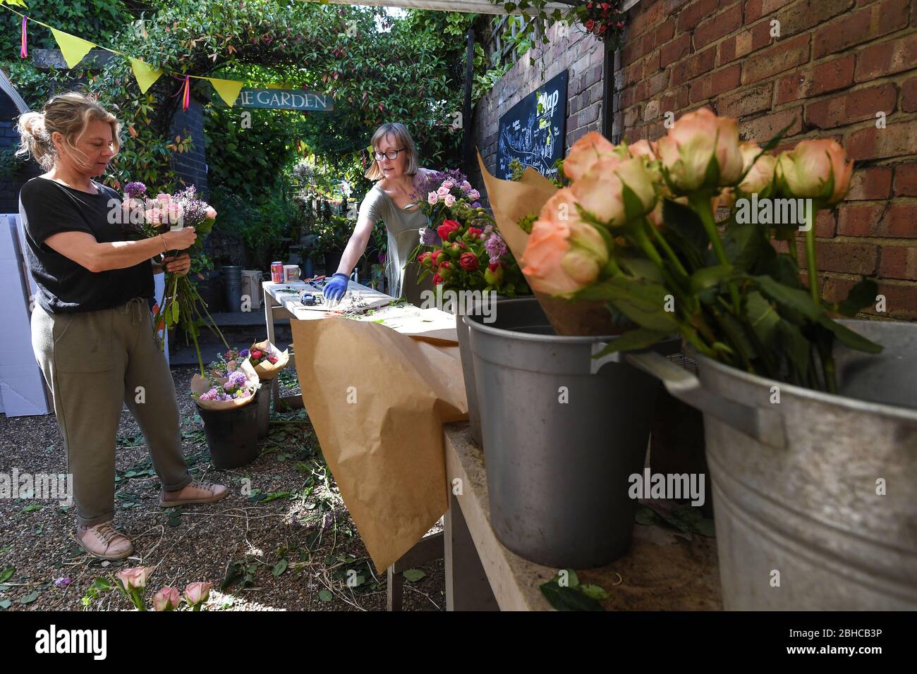 Florists Sam Hartley and Sandra Janssens (left) make bouquets of