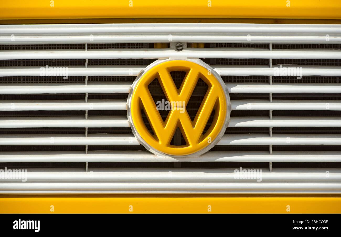 BERLIN - APR 23: Emblem of Volkswagen retro vintage car, yellow Volkswagen beetle car in Berlin on April 23. 2020 in Germany Stock Photo