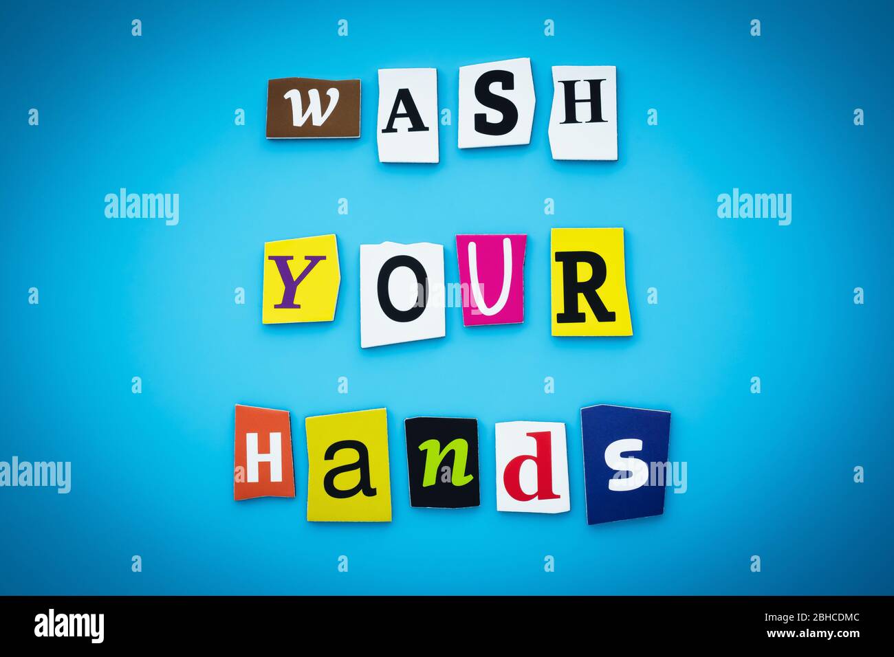 A word writing text - wash your hands. Cut letters on a blue background. Headline, banner with inscription. Coronavirus prevention concept Stock Photo