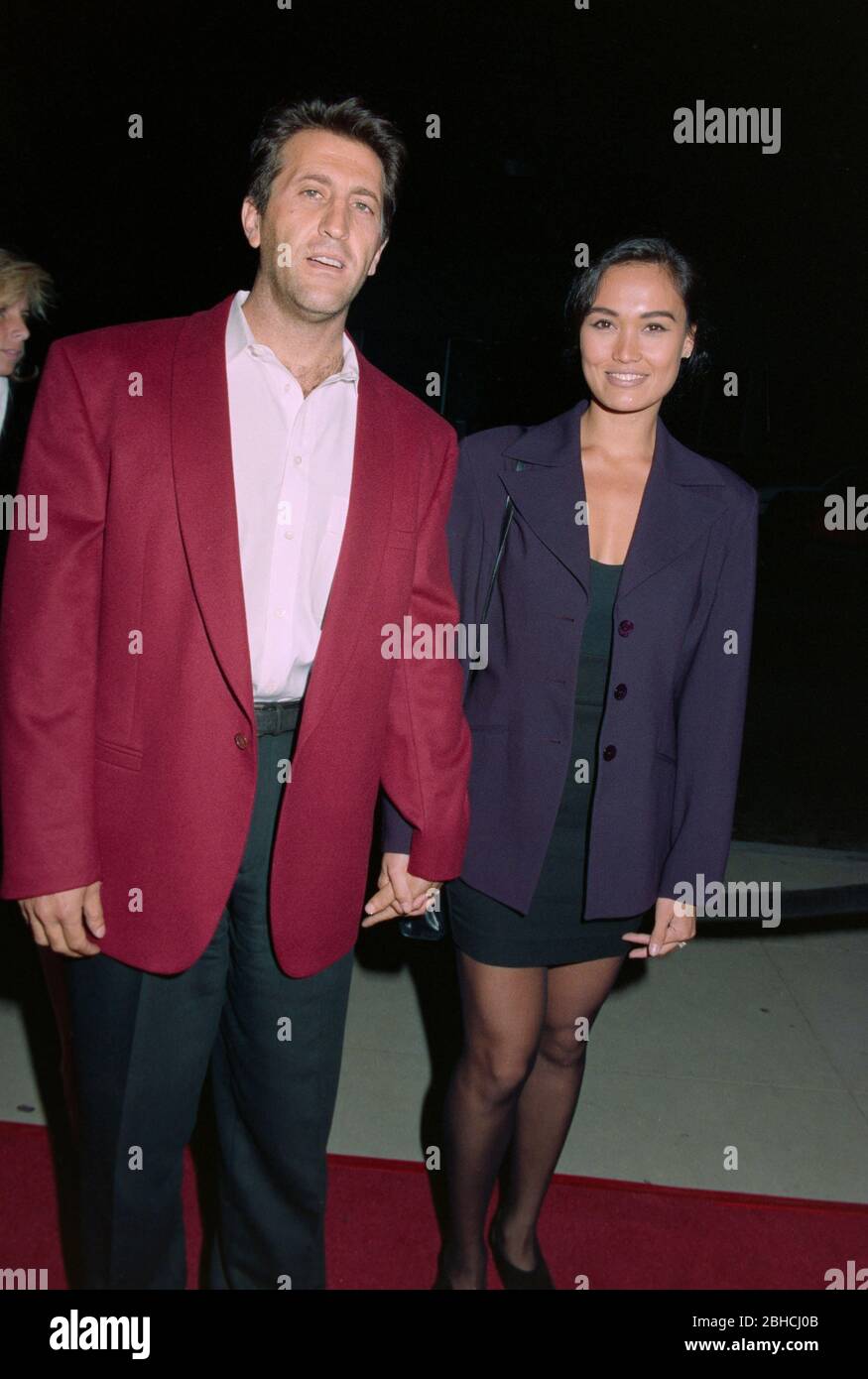 LOS ANGELES, CA. c.1993: Actress Tia Carrere & husband Elie Samaha.  File photo © Paul Smith/Featureflash Stock Photo