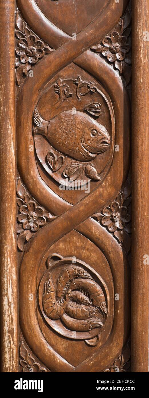 Woodcarvings depicting local seafood at the entrance to a seafood restaurant on the coast of Asturias, northern Spain Stock Photo