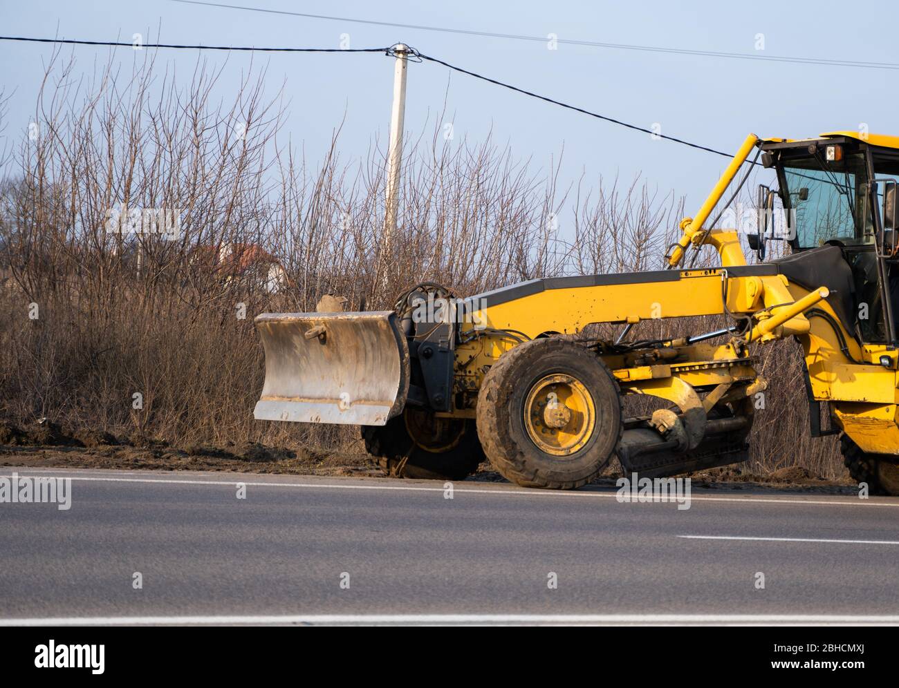 Grader is working on road construction. Grader industrial machine on