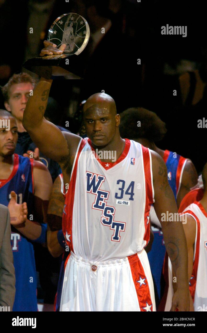 Shaquille O'Neal of the Los Angeles Lakers hoists most valuable player  trophy after scoring 24 points and grabbing 11 rebounds during 136-132 West  victory over the East in the NBA All-Star Game