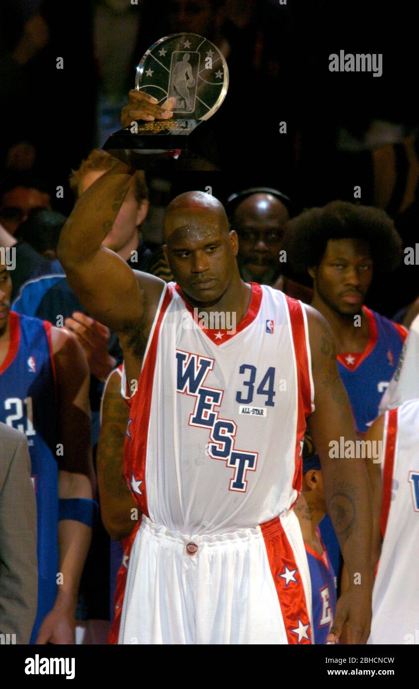 Shaquille O'Neal of the Los Angeles Lakers hoists most valuable player  trophy after scoring 24 points and grabbing 11 rebounds during 136-132 West  victory over the East in the NBA All-Star Game