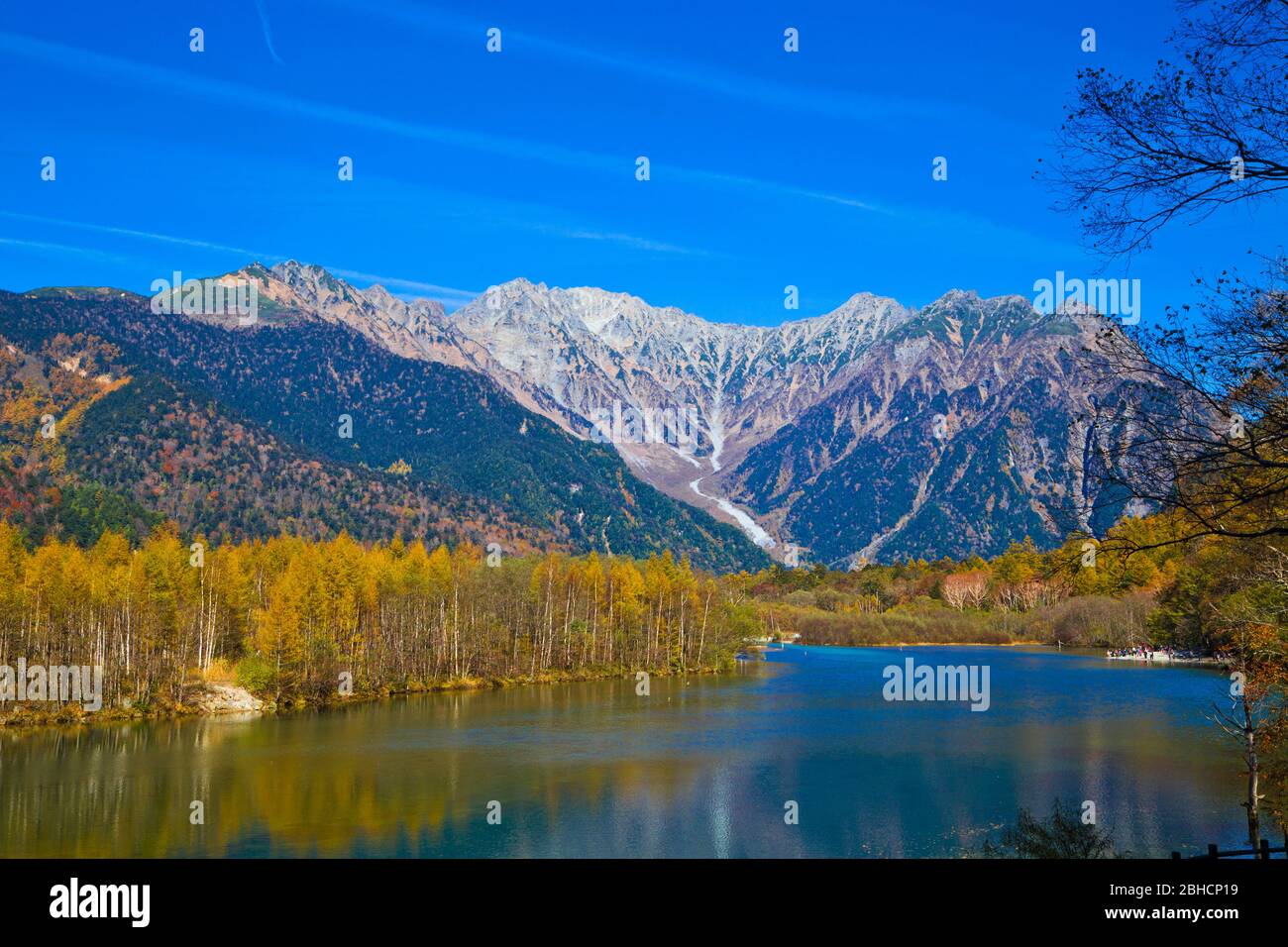 Taisho Pond Has A Beautiful Surface Which Reflects The Hotaka Mountains And With Surrounding Scenery Symbolizing Of Kamikochi National Park Stock Photo Alamy