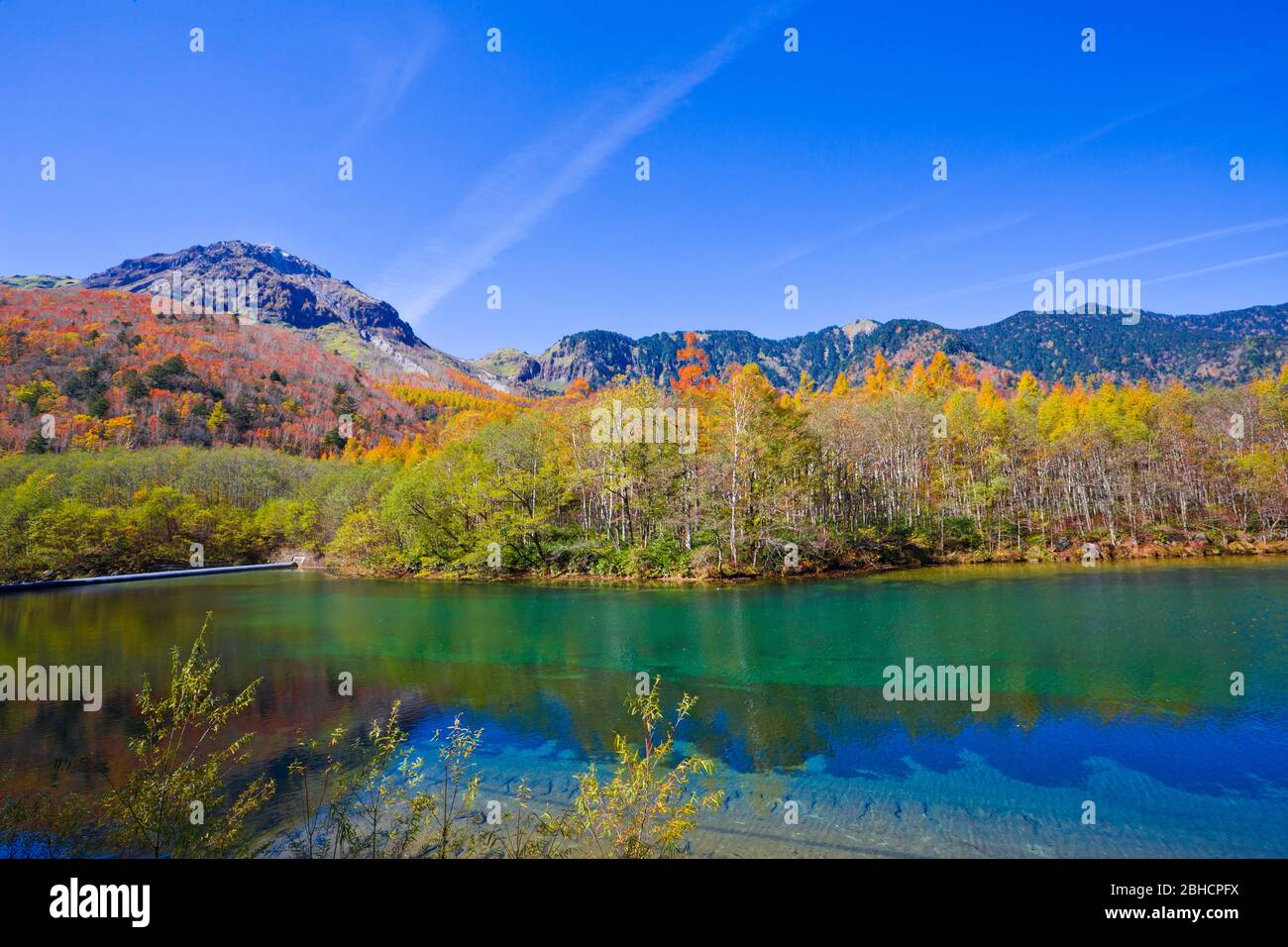Taisho Pond Has A Beautiful Surface Which Reflects The Hotaka Mountains And With Surrounding Scenery Symbolizing Of Kamikochi National Park Stock Photo Alamy