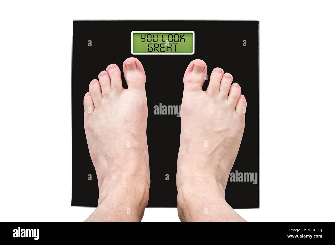 Man on scales with normal weight and good health, the inscription - you look great. Stock Photo