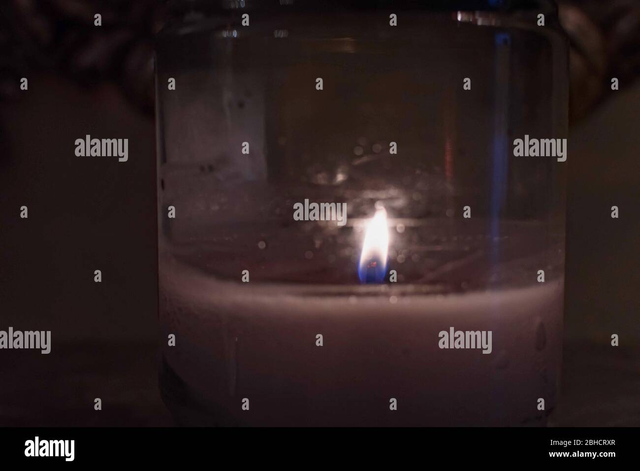 Candle burning inside a small jar. A jar with burning candle inside Stock Photo Alamy