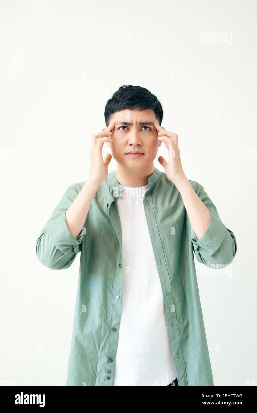 Depressed young business man holding his head Stock Photo - Alamy