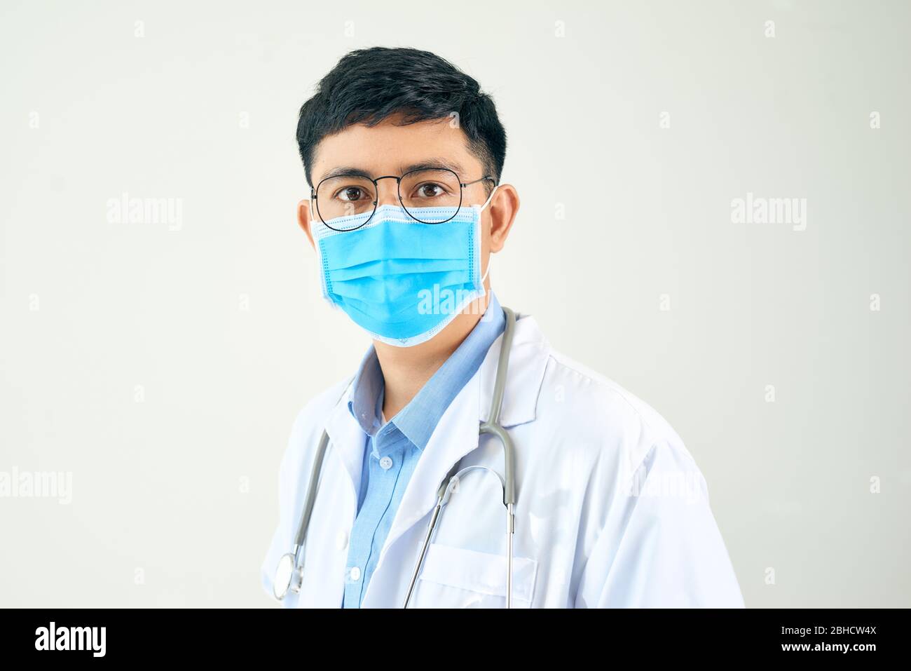 Young asian man in medical field, wearing a white coat and face mask ...