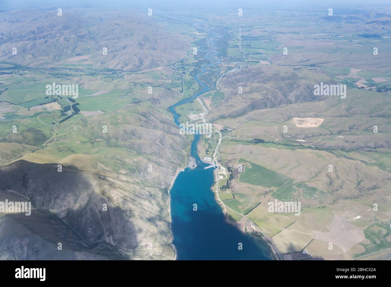 aerial, from a glider, of Waitaki dam and lake, shot in bright spring light from north, Canterbury, South Island, New Zealand Stock Photo
