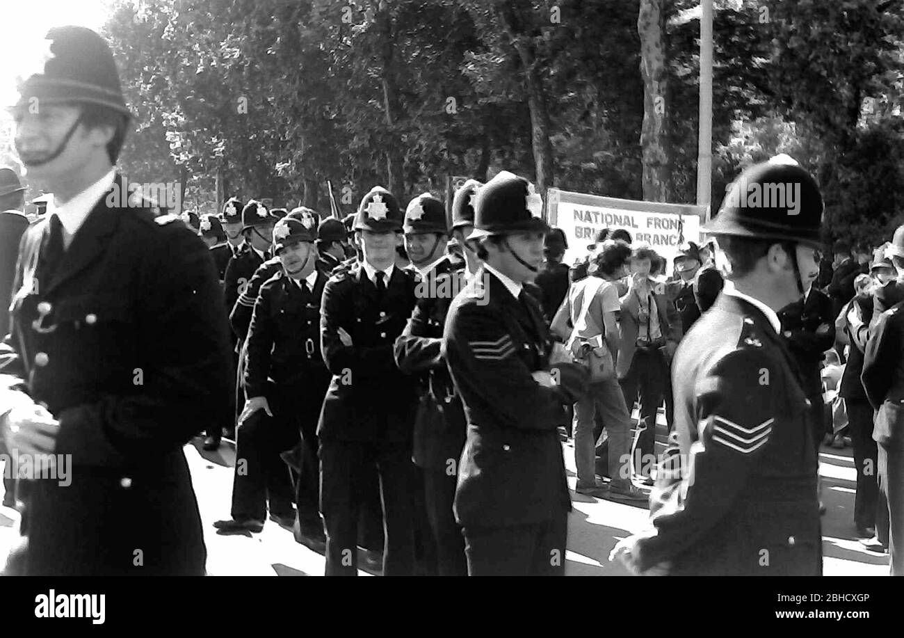 A far right National Front March, London, England, United Kingdom, surrounded by police officers, September, 1978. On the same day an Anti Nazi League march took place in London so the police were there in great numbers. Stock Photo