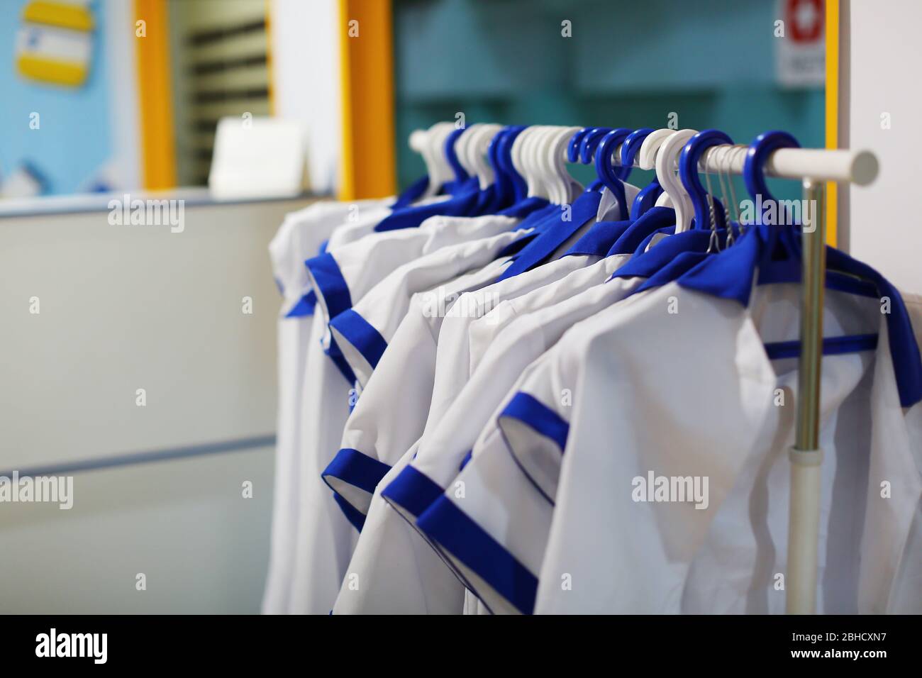 Hanger stand with medical uniform gowns. Medical or laboratory concept Stock Photo