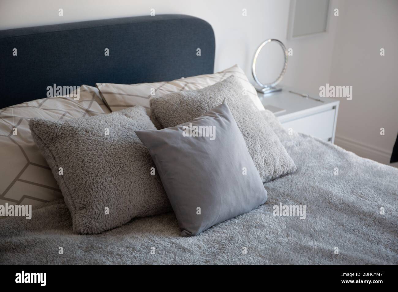 Grey pillows on a bed Stock Photo Alamy