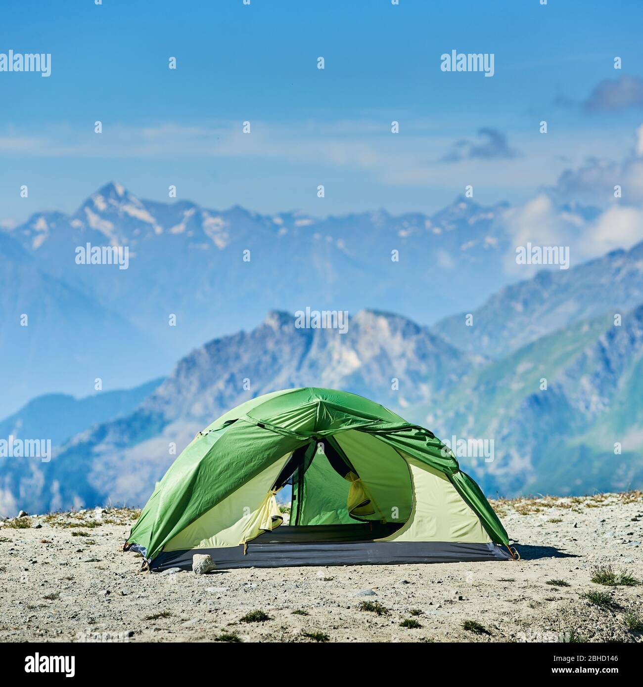 Beautiful view of green tourist tent standing in mountain valley in ...