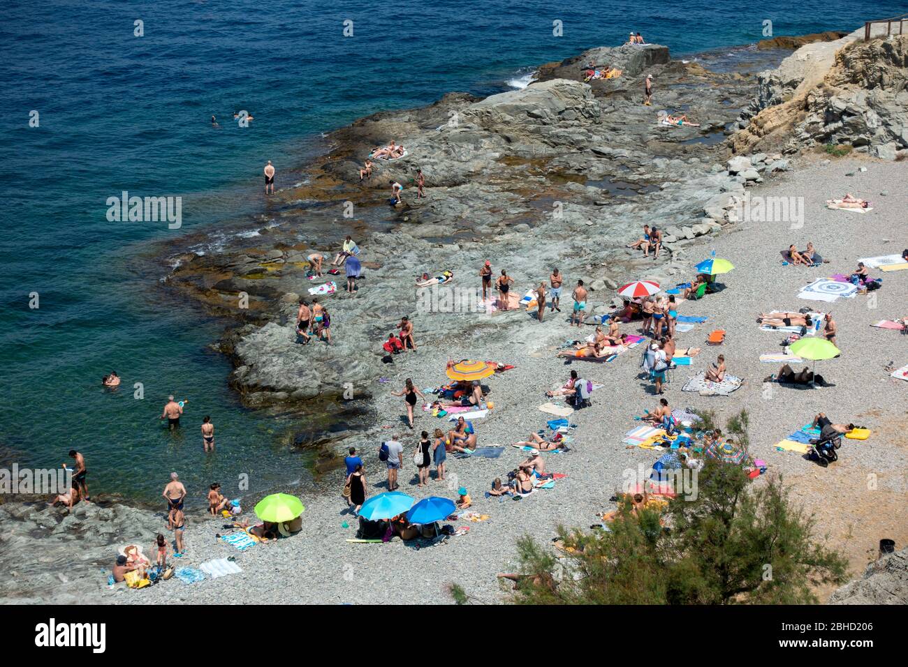 People swimming and sunbathing.Port de la Selva.Costa Brava.Gerona.Catalonia.Spain Stock Photo