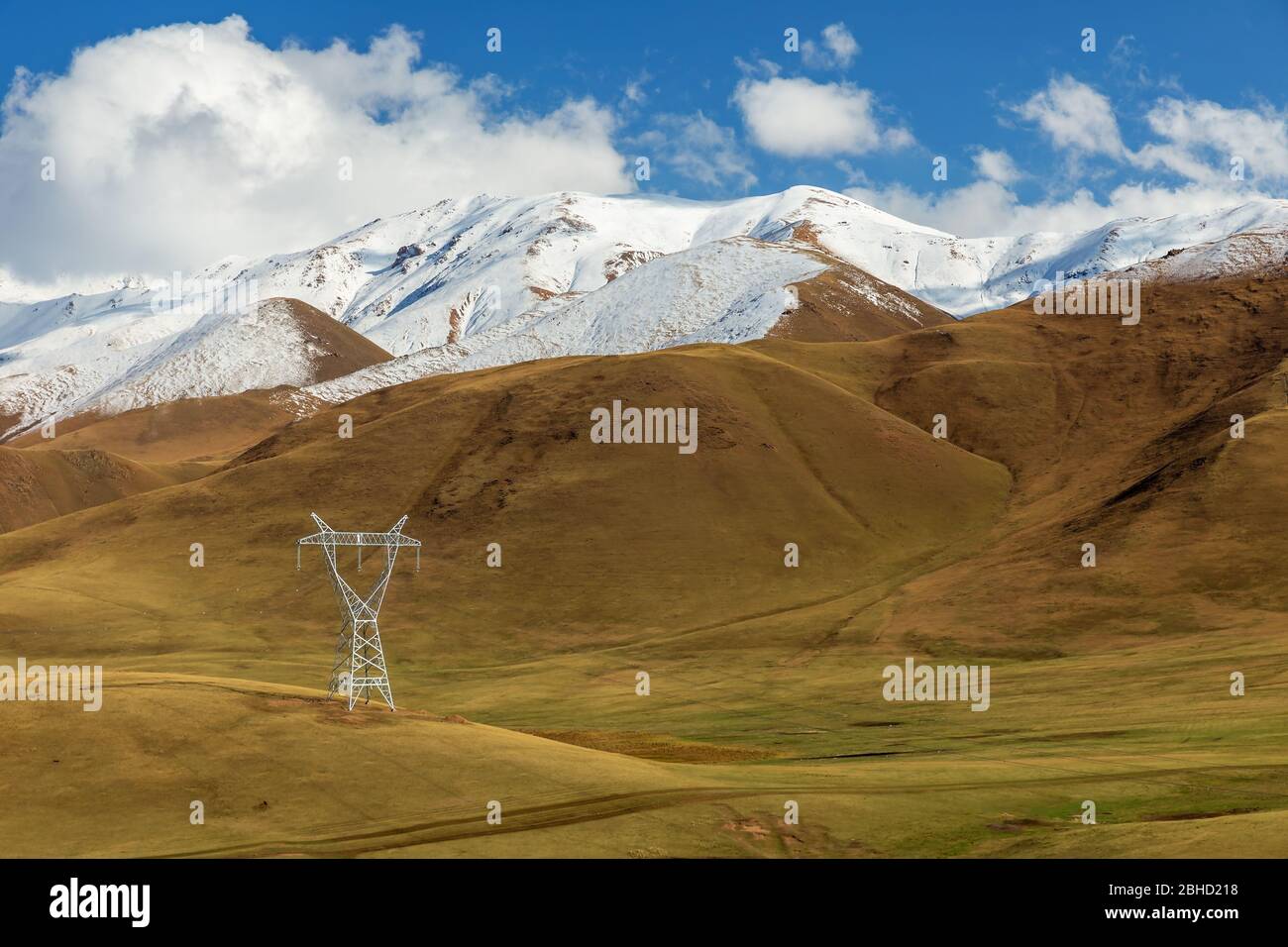 high voltage power line in the mountains of Kyrgyzstan, snowy mountains ...