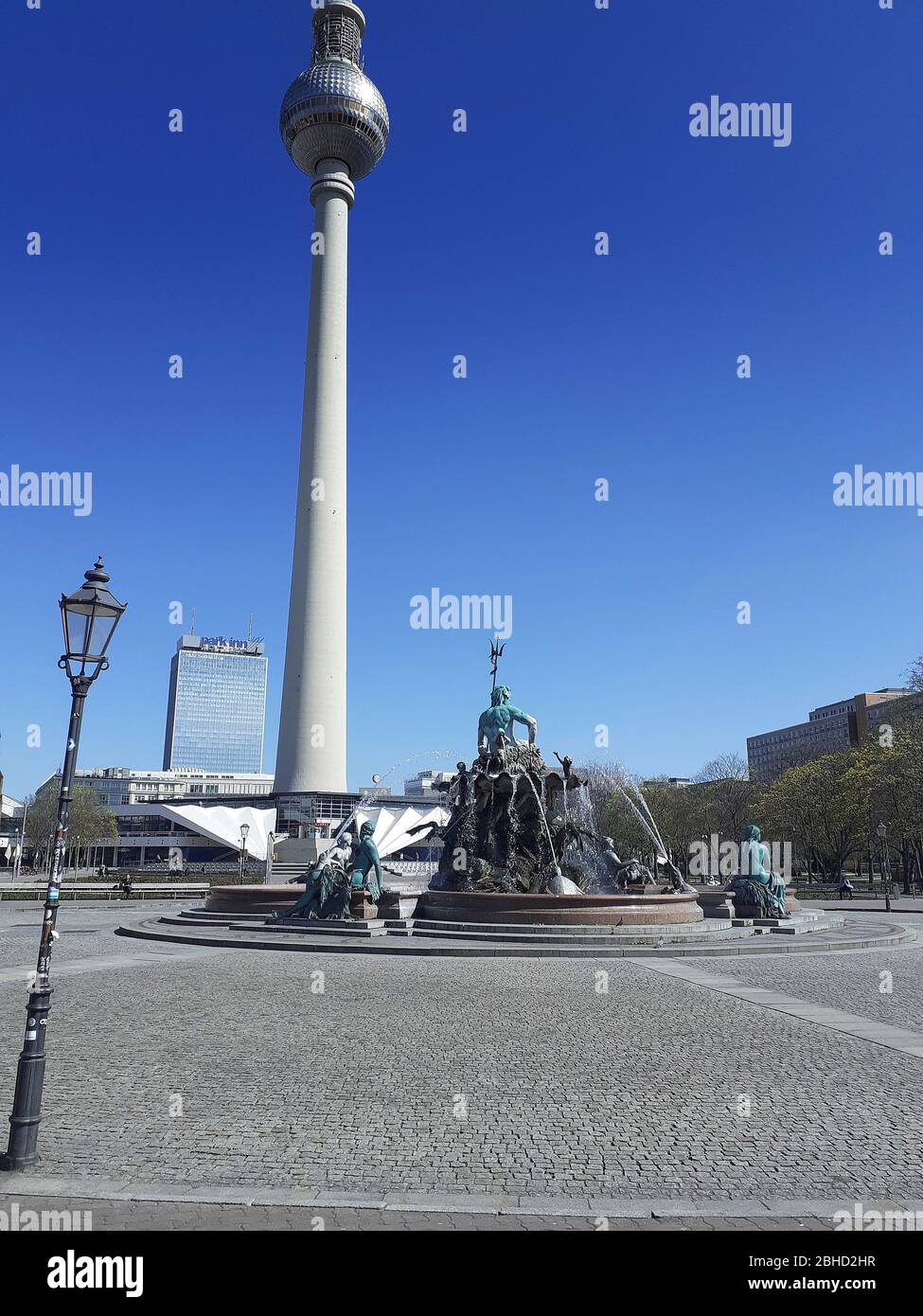 The Neptune Fountain with the Fernsehturm in the background, devoid of tourists during the lock-down due to the Coronavirus pandemic, April 2020, Berlin, Germany Stock Photo