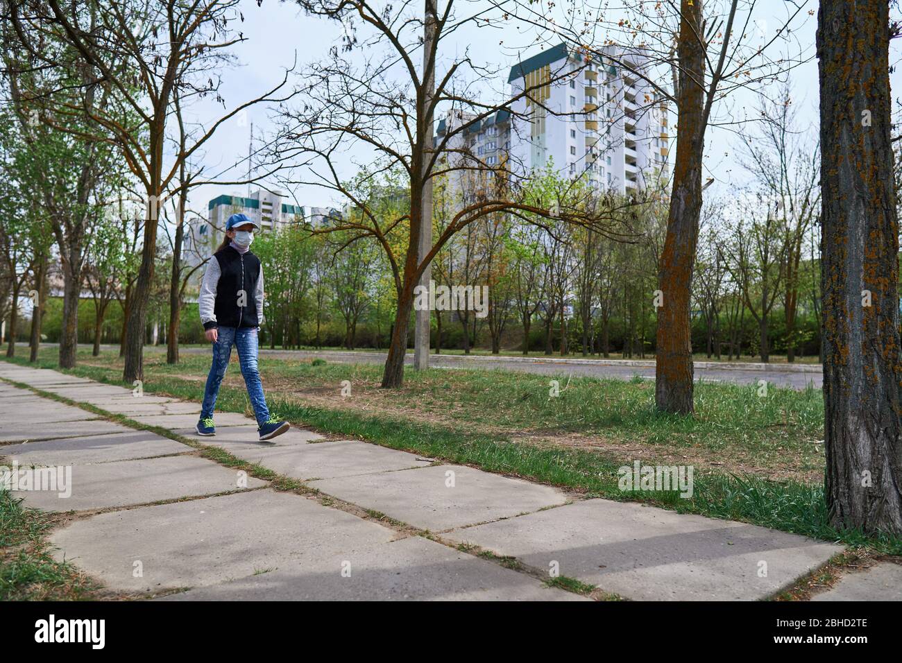 Image showcasing child girl walks down the street during the day, a pedestrian walkway ...
