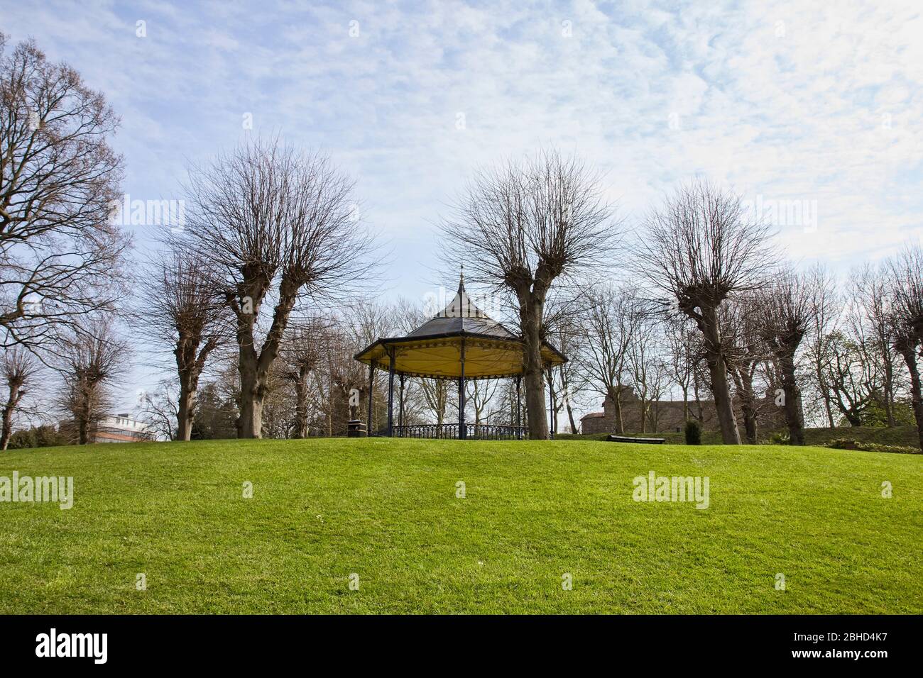 Empty Colchester Castle Park in England during lockdown in April 2020 due to coronavirus quarantine with bandstand and castle in the background. Stock Photo