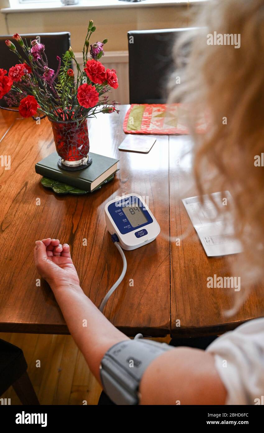 https://c8.alamy.com/comp/2BHD6FC/middle-aged-woman-using-an-omron-blood-pressure-testing-monitor-at-home-photograph-taken-by-simon-dack-2BHD6FC.jpg