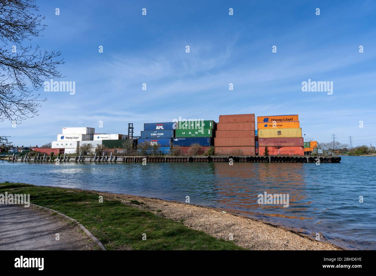 Shipping containers stacked high at Eling Wharf, Totton, Hampshire, England, UK - Eling Wharf is situated at the Northern End of Southampton Water. Stock Photo