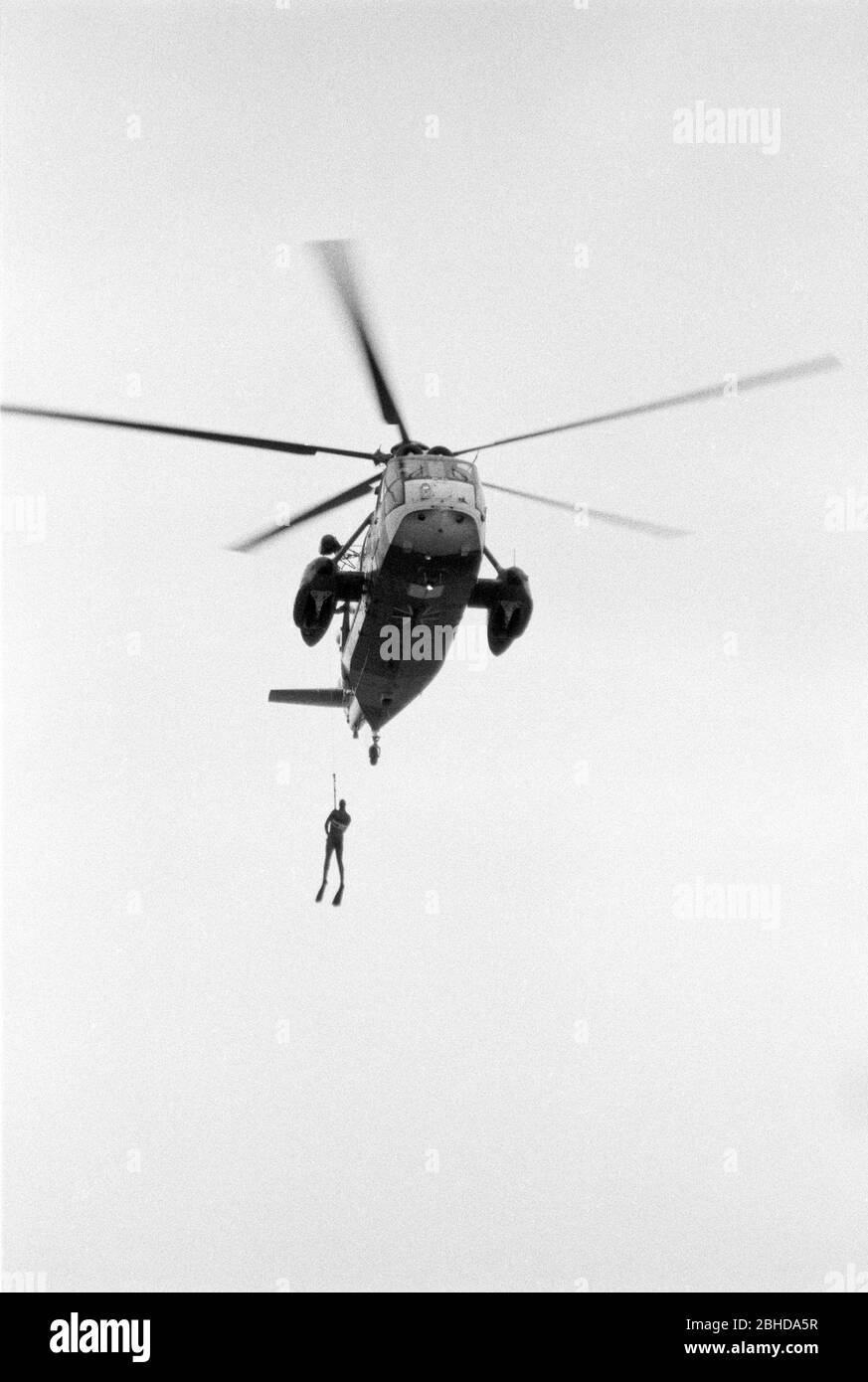 Rescue helicopter man on winch Black and White Stock Photos & Images ...