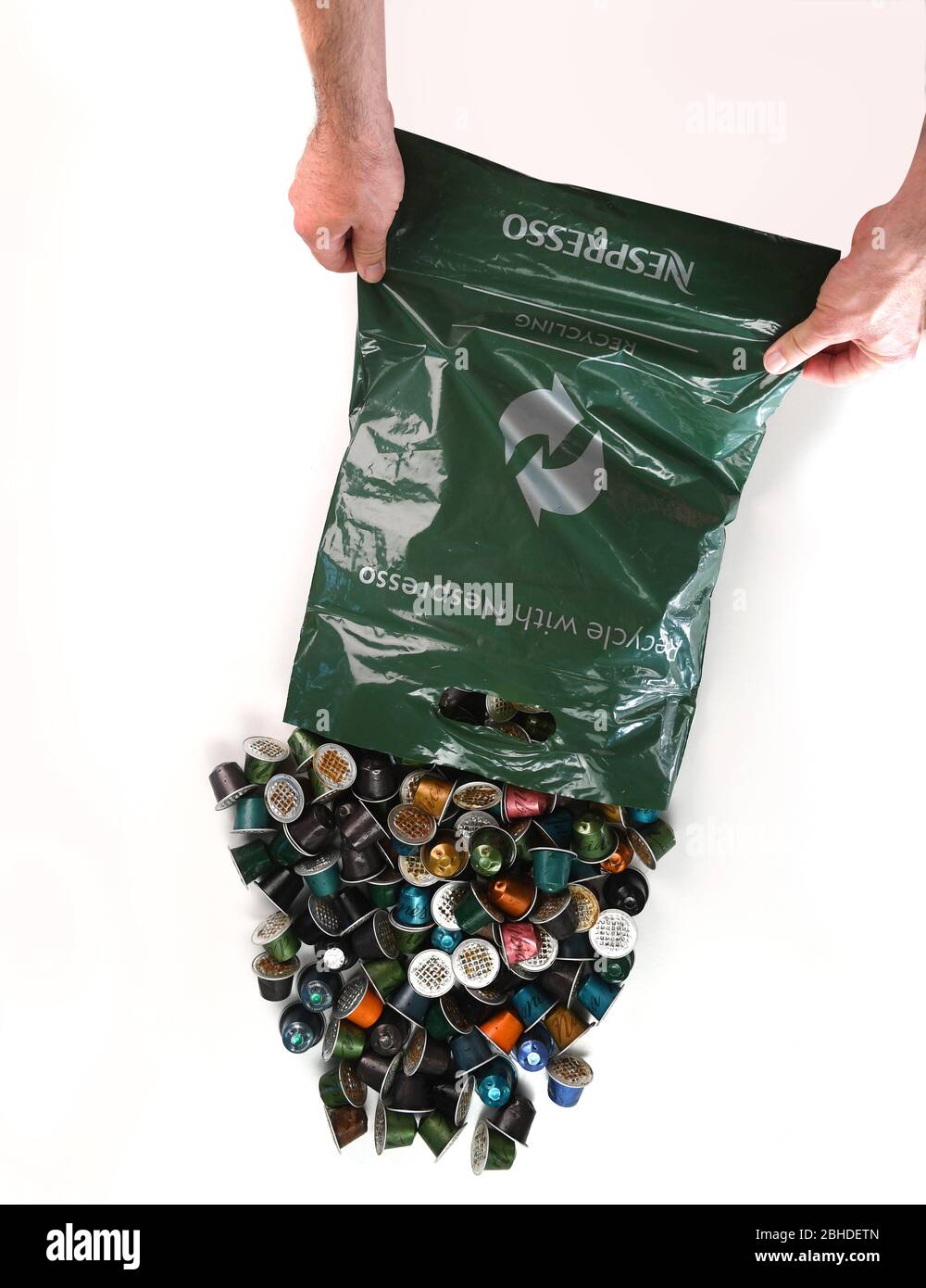 A Nespresso recycling bag in use with used coffee capsule pods on a white  background for isolation Stock Photo - Alamy