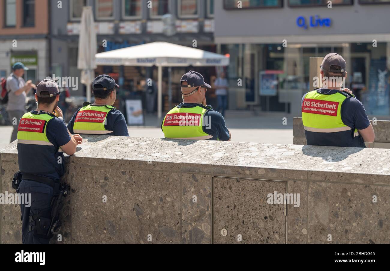 Munich, Germany. 25th Apr, 2020. Four men from DB Sicherheit der Deutschen Bahn are standing in the sun at Marienplatz, close to the S-Bahn and U-Bahn stations, in the city centre at a distance from each other. Credit: Peter Kneffel/dpa/Alamy Live News Stock Photo
