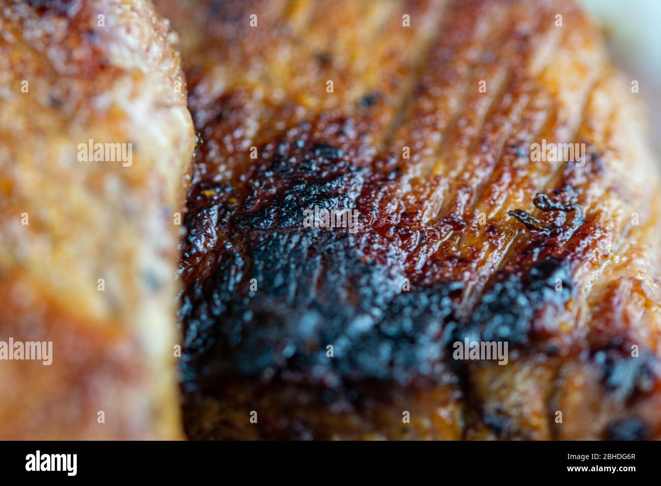 Macro on a juicy, delicious beef steak cooked in a frying pan Stock Photo