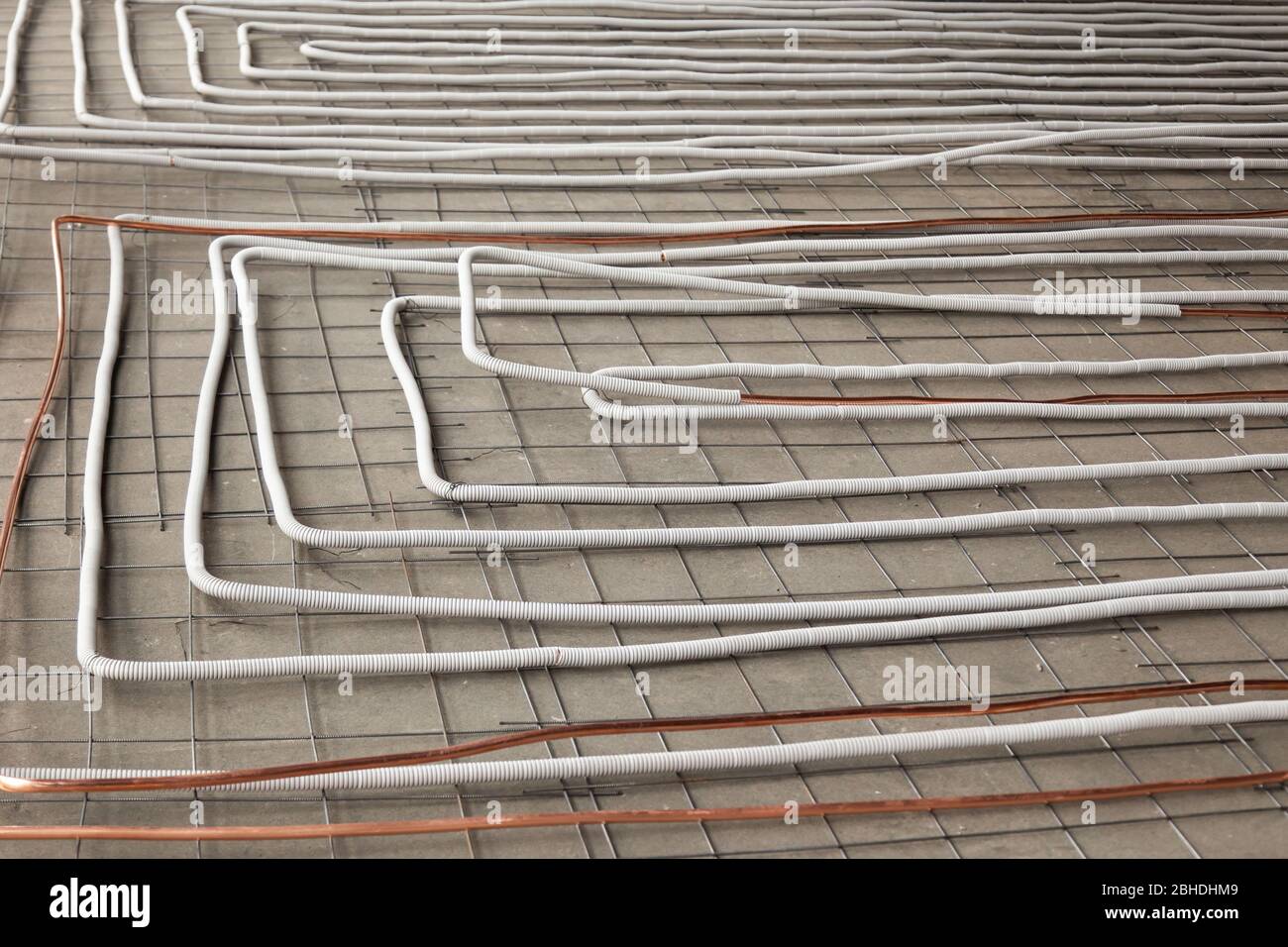 Bent new copper pipes laying on concrete floor Stock Photo Alamy