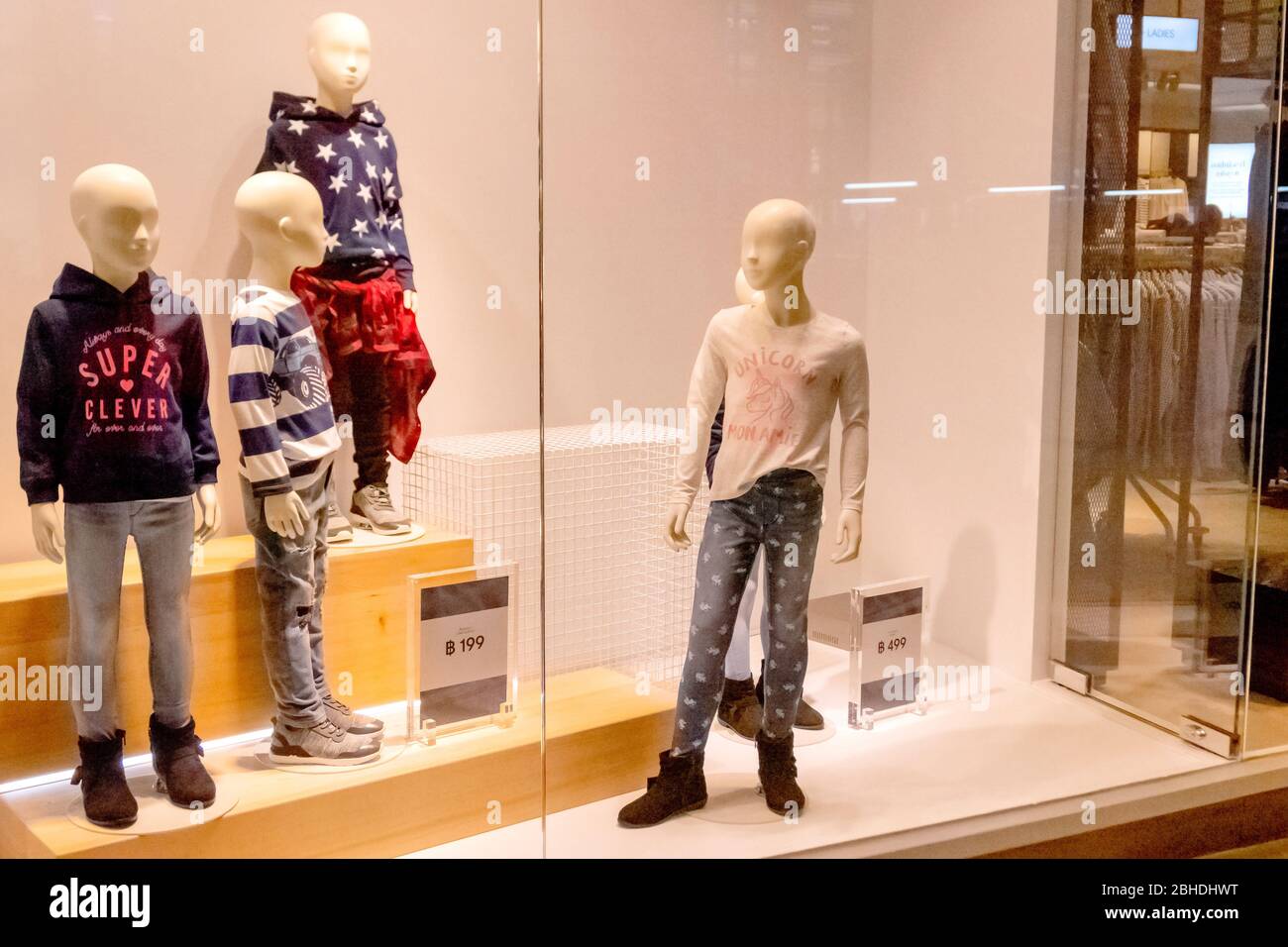 The H M clothed mannequins with children fashion clothing in the glass window display in Blueport shopping mall Hua Hin Thailand January 28 2019 Stock Photo Alamy