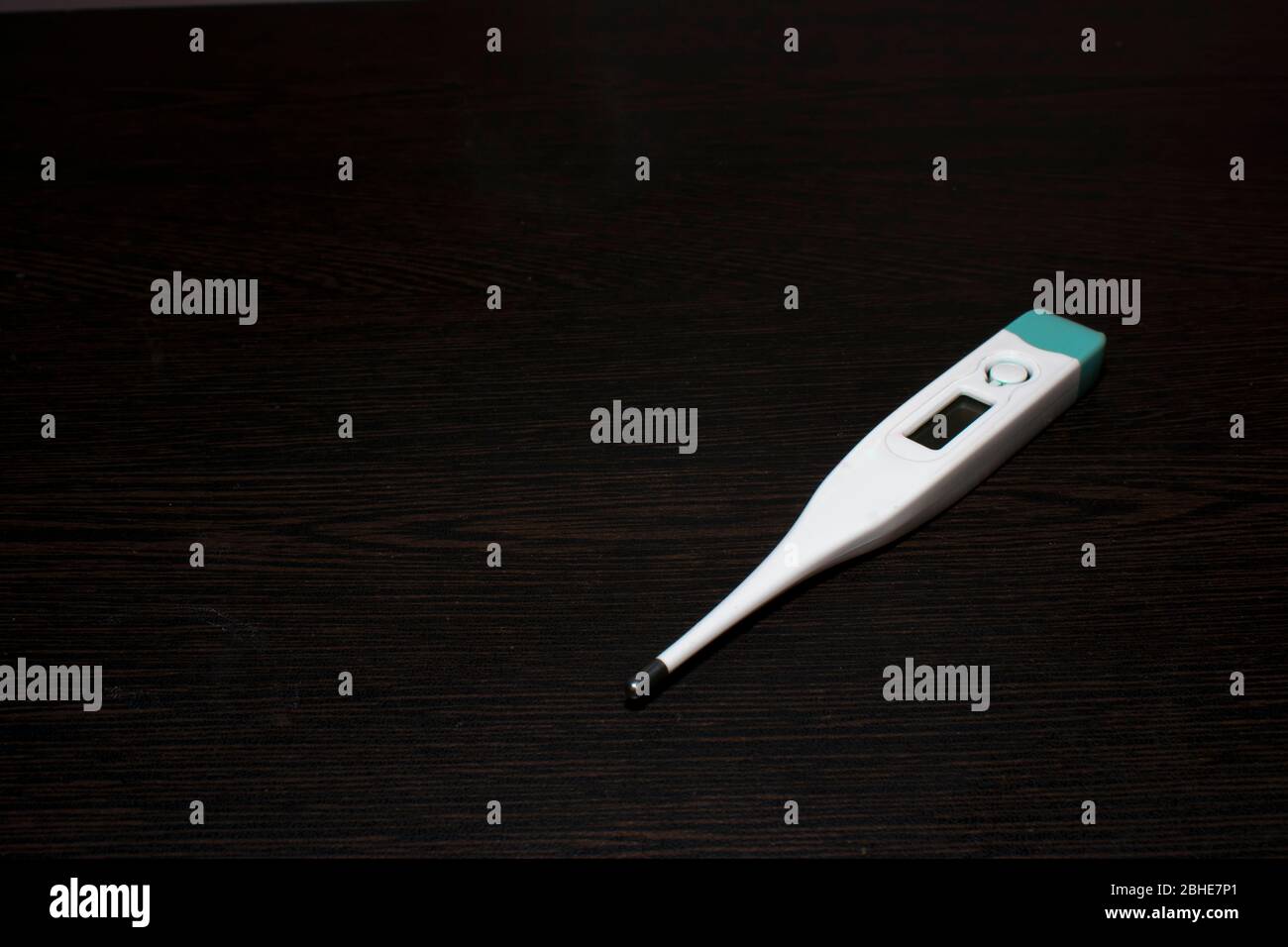 Digital Thermometer on black background to check body temperature Stock Photo