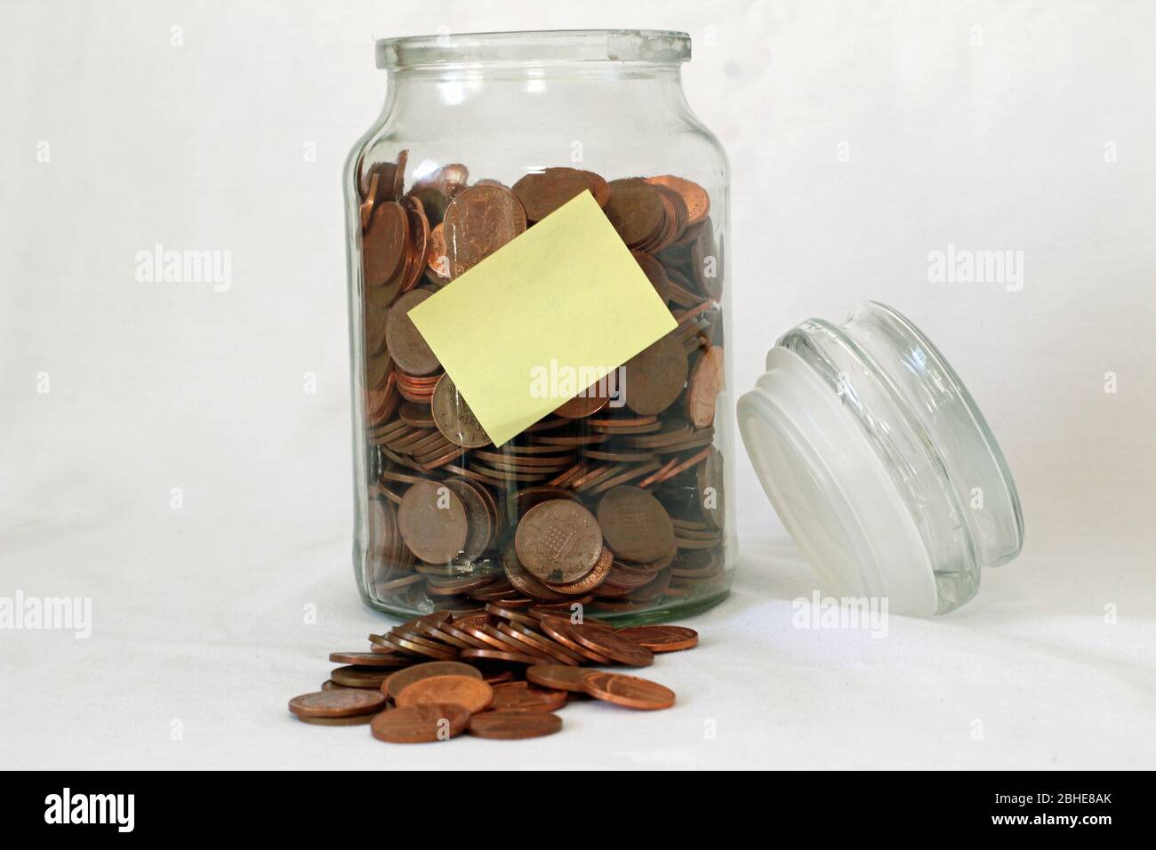 Glass savings jar with coins collection or savings for a rainy day Stock Photo