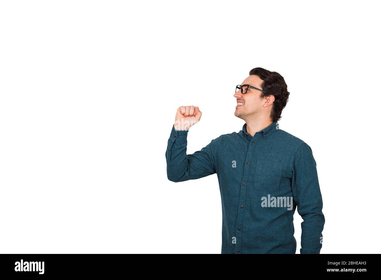 Side view of joyful businessman speaks loud, as holding an invisible imaginary megaphone or microphone in his hand isolated on white background with c Stock Photo