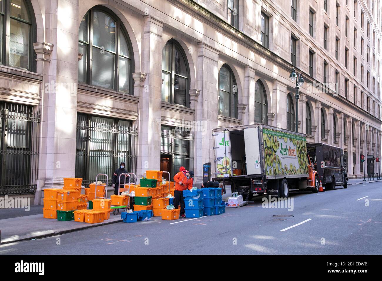 Essential workers preparing containers for delivery, New York City. Stock Photo