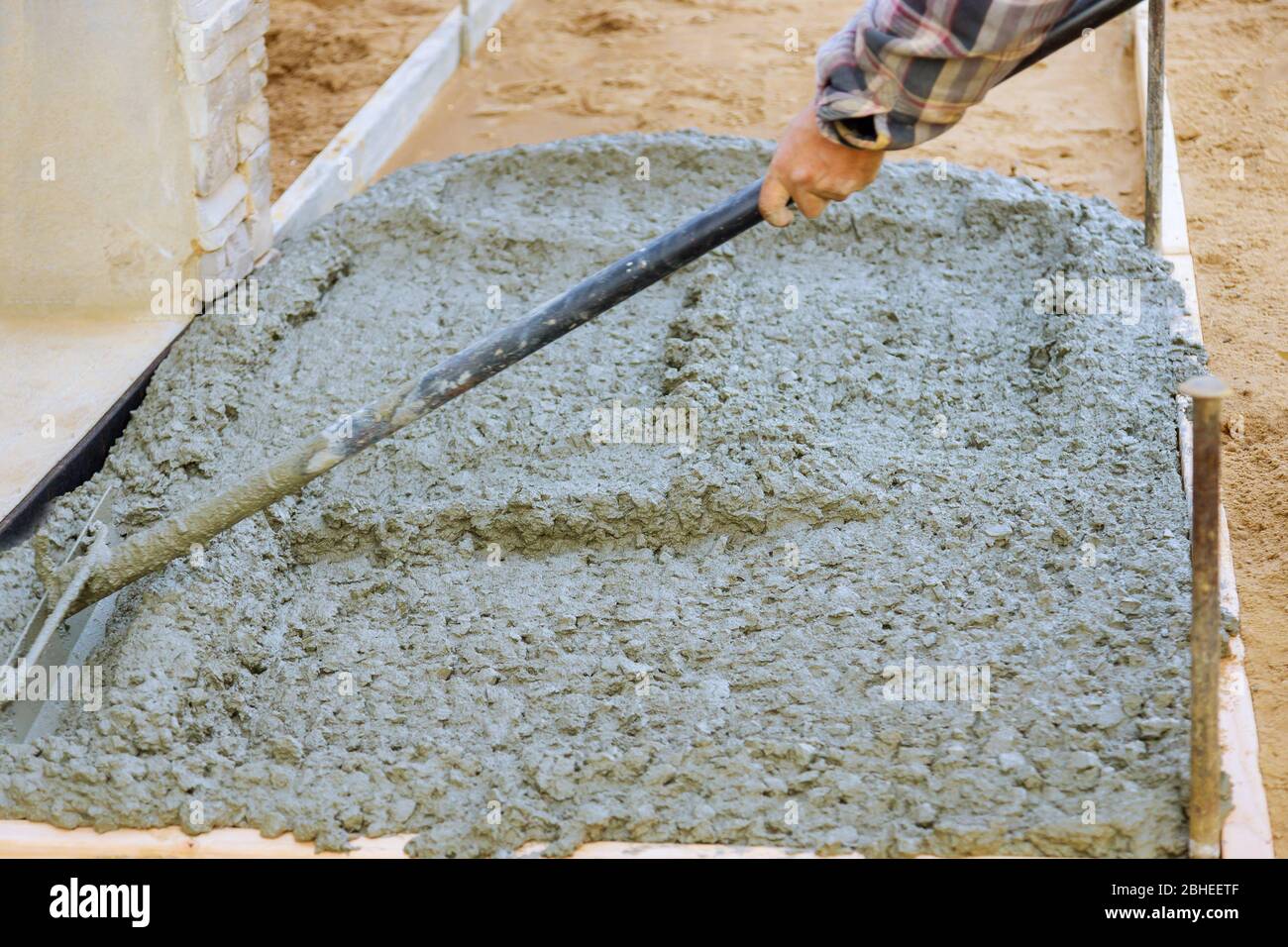 Making of freshly poured cement on concrete pavement sidewalk in new residential home Stock