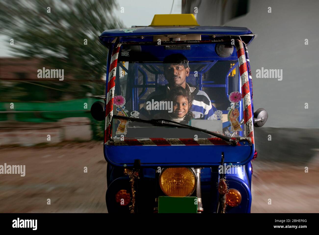 indian father riding vehicle with his child, India Stock Photo
